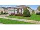 Charming single-story home featuring a well-manicured lawn, a two-car garage, and a cozy front porch at 2949 Marlberry Ln, Clermont, FL 34714