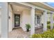 Inviting front porch with seating, decorative wreath, and brick flooring at 2949 Marlberry Ln, Clermont, FL 34714