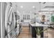 Bright kitchen with stainless steel appliances, a kitchen island with seating, and an open layout at 2949 Marlberry Ln, Clermont, FL 34714