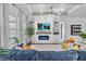 Stylish living room with large windows, built-in shelving, and hardwood floors at 2949 Marlberry Ln, Clermont, FL 34714