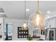 Modern kitchen showcases hanging glass pendant lights with stainless steel appliances at 2949 Marlberry Ln, Clermont, FL 34714