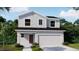 Charming two-story home with gray siding and well-maintained landscaping in a lush green neighborhood at 3848 Bluethread Way, Poinciana, FL 34759