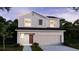 Charming two-story home featuring gray siding, a two-car garage, and a well-manicured lawn at 3226 Viceroy Ct, Poinciana, FL 34759
