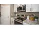 Well-appointed kitchen featuring stainless steel appliances, granite countertops, and ample cabinet space at 3226 Viceroy Ct, Poinciana, FL 34759