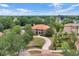 Aerial view of the property showcasing its landscaping within a picturesque neighborhood at 3414 Cocard Ct, Windermere, FL 34786