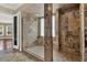 Bathroom with a stone tiled shower, glass door and natural light, with neutral paint at 3414 Cocard Ct, Windermere, FL 34786