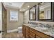 Bathroom boasts double granite vanity, wood cabinets, tile floors, and a glass enclosed shower at 3414 Cocard Ct, Windermere, FL 34786