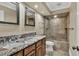 Bathroom featuring double sinks, granite countertops, and a tiled shower at 3414 Cocard Ct, Windermere, FL 34786