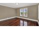 Bedroom featuring hardwood floors, base trim, and neutral paint at 3414 Cocard Ct, Windermere, FL 34786