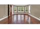 Bedroom featuring hardwood floors and large windows, closet, and neutral paint at 3414 Cocard Ct, Windermere, FL 34786