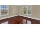 Spacious bedroom with beautiful wood floors, large windows and white trim throughout the room at 3414 Cocard Ct, Windermere, FL 34786