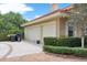 Attached three car garage with large driveway and lush green landscaping at 3414 Cocard Ct, Windermere, FL 34786
