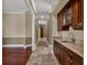 Hallway featuring a wet bar with wooden cabinetry and granite countertops at 3414 Cocard Ct, Windermere, FL 34786