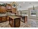 Spacious kitchen with an island, granite countertops, stone tile floors, and an open floor plan at 3414 Cocard Ct, Windermere, FL 34786