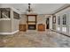 Open-concept living room with stone floors, a fireplace, built-in cabinets, and natural lighting at 3414 Cocard Ct, Windermere, FL 34786