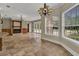 Spacious living room featuring a fireplace, and windows that provide lots of natural light and pool views at 3414 Cocard Ct, Windermere, FL 34786