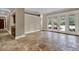 Bright, open living room with stone tile floors and large French doors leading to outdoor space at 3414 Cocard Ct, Windermere, FL 34786