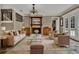 A sun-filled living room offering stylish furnishings, a fireplace, and french doors that lead to the outdoors at 3414 Cocard Ct, Windermere, FL 34786