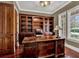 A well-appointed office features wood built-ins and a large executive desk at 3414 Cocard Ct, Windermere, FL 34786
