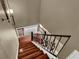 Elegant staircase features wood steps with decorative iron railing and wall sconce lighting at 3414 Cocard Ct, Windermere, FL 34786