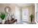 Welcoming foyer featuring elegant decor, a stylish mirror, and a bright entryway at 3860 Bluethread Way, Poinciana, FL 34759