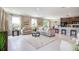 Bright living room with plush seating, a stylish coffee table, and an open view into the kitchen at 3860 Bluethread Way, Poinciana, FL 34759