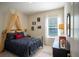 Inviting bedroom with a whimsical canopy bed complemented by a bright window and stylish decor at 3864 Bluethread Way, Poinciana, FL 34759