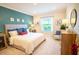 A beautifully decorated bedroom features an accent wall and a comfortable queen size bed at 3864 Bluethread Way, Poinciana, FL 34759