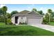 Charming one-story home with well-manicured lawn and attached two-car garage at 3864 Bluethread Way, Poinciana, FL 34759