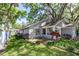 Backyard featuring a well-maintained lawn, mature trees, and a stone patio perfect for outdoor seating at 418 S Summerlin Ave, Sanford, FL 32771