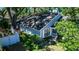 Exterior view of the home showcasing the backyard, landscaping, and mature trees providing shade at 418 S Summerlin Ave, Sanford, FL 32771