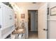 Bathroom with granite countertop vanity, linen closet, and decorative mirror at 418 S Summerlin Ave, Sanford, FL 32771