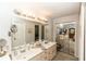Bathroom featuring double vanity, bright lighting and mirrored closet doors at 418 S Summerlin Ave, Sanford, FL 32771