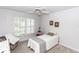 Comfortable bedroom featuring a ceiling fan, plantation shutters, and neutral decor at 418 S Summerlin Ave, Sanford, FL 32771