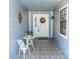 Home's front entrance featuring a tiled foyer, decorative wreath, and a charming table with chairs at 418 S Summerlin Ave, Sanford, FL 32771