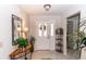 Inviting foyer features decorative mirror, tile floor, and glass front door allowing for ample natural light at 418 S Summerlin Ave, Sanford, FL 32771