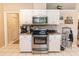 Bright kitchen features white cabinets, stainless steel appliances, and granite countertops at 418 S Summerlin Ave, Sanford, FL 32771