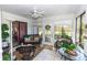Inviting sunroom with tile floor, ceiling fan and multiple seating areas at 418 S Summerlin Ave, Sanford, FL 32771