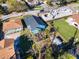 An aerial view featuring a backyard, mature trees, a lush landscape, and a partially-constructed building nearby at 434 E Harding St, Orlando, FL 32806
