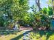 Lush backyard featuring a stone pathway, serene landscaping, and peaceful zen elements at 434 E Harding St, Orlando, FL 32806