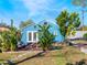 Backyard featuring a blue house with French doors, lush greenery, and patio furniture at 434 E Harding St, Orlando, FL 32806