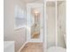 Bright bathroom featuring a shower, toilet, window with blinds, and a view to the vanity and mirror at 434 E Harding St, Orlando, FL 32806