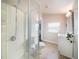 Bright bathroom featuring a glass-enclosed shower and white vanity with modern fixtures at 434 E Harding St, Orlando, FL 32806
