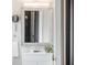 Close-up on the bathroom vanity with a decorative mirror, faucet, and plant at 434 E Harding St, Orlando, FL 32806