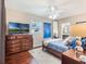 Comfortable bedroom with a ceiling fan, large dresser, and access to ensuite bathroom at 434 E Harding St, Orlando, FL 32806