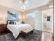 Cozy bedroom with white bedding, a wood accent table, and ensuite bathroom at 434 E Harding St, Orlando, FL 32806