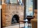 Close up of brick fireplace topped with decorative vases and mirror at 434 E Harding St, Orlando, FL 32806