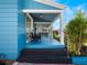 Stylish covered porch with black chairs and blue ceiling, offers a relaxing outdoor space at 434 E Harding St, Orlando, FL 32806