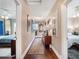 Hallway featuring hardwood floors, a decorative rug, and wall decor leading to bedrooms at 434 E Harding St, Orlando, FL 32806