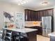 Contemporary kitchen with dark cabinets, white countertops, and stainless steel appliances at 434 E Harding St, Orlando, FL 32806